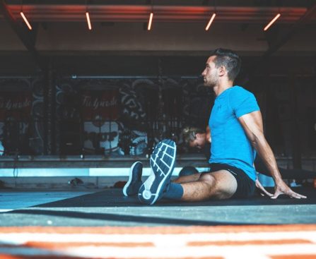 man sitting on exercise mat